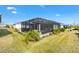 Wide angle view of the backyard and screened in lanai, perfect for outdoor entertaining and enjoying the Florida weather at 2484 Lynette Ave, The Villages, FL 32163