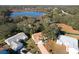 Aerial view of a house near a lake in a quiet residential neighborhood at 25107 Meriweather Rd, Leesburg, FL 34748