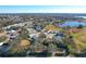 Aerial view of community with a lake and various houses at 25107 Meriweather Rd, Leesburg, FL 34748