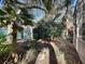 Landscaped backyard with a shaded path and tropical plants at 25107 Meriweather Rd, Leesburg, FL 34748