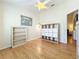 Bedroom featuring wood floors, built-in shelving, and access to another room at 25107 Meriweather Rd, Leesburg, FL 34748