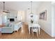 Bright dining room featuring hardwood floors and a farmhouse style table at 25107 Meriweather Rd, Leesburg, FL 34748