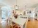 Bright dining room with white table and chairs, hardwood floors, and access to a patio at 25107 Meriweather Rd, Leesburg, FL 34748