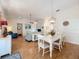 Charming dining room with white table and chairs, hardwood floors, and a stylish light fixture at 25107 Meriweather Rd, Leesburg, FL 34748