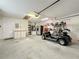 Garage with golf cart, extra storage, and workbench at 25107 Meriweather Rd, Leesburg, FL 34748