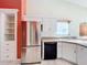 Stainless steel refrigerator and white cabinetry in kitchen at 25107 Meriweather Rd, Leesburg, FL 34748