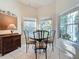 Cozy kitchen nook with a round table and chairs, offering ample natural light at 25107 Meriweather Rd, Leesburg, FL 34748