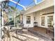 Enjoy this screened porch with paver patio and French doors at 25107 Meriweather Rd, Leesburg, FL 34748