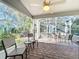 Relaxing screened porch with patio furniture and ceiling fan at 25107 Meriweather Rd, Leesburg, FL 34748