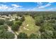 Aerial view showing a golf course and surrounding houses at 25236 River Crest Dr, Leesburg, FL 34748