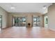 Open living area with wood-look floors and sliding glass doors at 25236 River Crest Dr, Leesburg, FL 34748