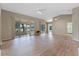 Living room featuring wood-look floors and multiple sliding glass doors at 25236 River Crest Dr, Leesburg, FL 34748