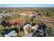 Aerial view of a residential neighborhood with houses, landscaping, and a pond at 25339 Hibiscus St, Leesburg, FL 34748