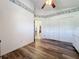 Bedroom with wood-look floors and ample closet space at 25339 Hibiscus St, Leesburg, FL 34748