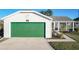 House with green garage door and landscaped yard at 25339 Hibiscus St, Leesburg, FL 34748