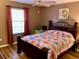 Bright bedroom with a floral comforter and wood-framed bed at 2552 Mariel Way, The Villages, FL 32162