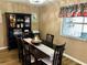 Bright dining room with dark wood table and hutch at 2552 Mariel Way, The Villages, FL 32162