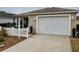 House exterior with attached garage and white picket fence at 2552 Mariel Way, The Villages, FL 32162