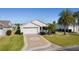 Single-story home with attached garage and landscaped yard at 2565 Edenville Path, The Villages, FL 32162