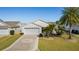 Single-story house with attached garage and a decorative driveway at 2565 Edenville Path, The Villages, FL 32162