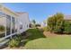 Landscaped backyard with grass and bushes between houses at 2565 Edenville Path, The Villages, FL 32162