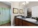 Bathroom with double sinks and a walk-in shower at 2565 Edenville Path, The Villages, FL 32162