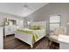 Main bedroom with a white dresser and a leafy green comforter at 2565 Edenville Path, The Villages, FL 32162