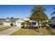 Single-story home with a palm tree and circular driveway at 2565 Edenville Path, The Villages, FL 32162