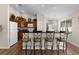 Kitchen with wood cabinets, breakfast bar, and view into the dining area at 2565 Edenville Path, The Villages, FL 32162