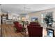 Bright living room with hardwood floors, comfy seating, and a view into the kitchen at 2565 Edenville Path, The Villages, FL 32162