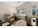 Relaxing living room with two recliners, a TV, and large windows at 2565 Edenville Path, The Villages, FL 32162