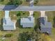 Aerial view of three homes in a quiet neighborhood at 26154 Newcombe Cir, Leesburg, FL 34748