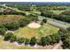 Aerial view of a baseball field nestled in a wooded area near a highway at 26154 Newcombe Cir, Leesburg, FL 34748