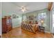 Bedroom with hardwood floors, daybed, and wooden dresser at 26154 Newcombe Cir, Leesburg, FL 34748