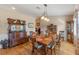 Formal dining room with wood floors, antique furniture, and chandelier at 26154 Newcombe Cir, Leesburg, FL 34748