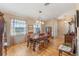 Formal dining room with wood floors, antique furniture, and chandelier at 26154 Newcombe Cir, Leesburg, FL 34748