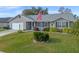 Gray siding, American flag, and well-manicured lawn at 26154 Newcombe Cir, Leesburg, FL 34748