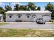 Building exterior, featuring a white metal building with a truck parked in front at 26154 Newcombe Cir, Leesburg, FL 34748