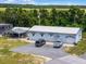 Aerial view of a light-blue office building with parking and a covered area at 26154 Newcombe Cir, Leesburg, FL 34748