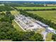 Aerial view of an RV storage facility with numerous RVs, boats, and a main building at 26154 Newcombe Cir, Leesburg, FL 34748