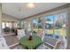 Sunroom with tiled floor, table and chairs, and backyard view at 26154 Newcombe Cir, Leesburg, FL 34748