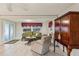 Living room features a green sofa, beige armchair, and a wooden cabinet at 2753 Vindale Rd, Tavares, FL 32778