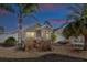 Tan house with a two-car garage and landscaped front yard at dusk at 2775 Sw 158Th St, Ocala, FL 34473