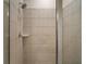 Shower with tile surround and a shower caddy at 29567 Caspian St, Leesburg, FL 34748