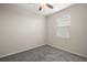 Well-lit bedroom featuring neutral wall paint and carpet at 29567 Caspian St, Leesburg, FL 34748