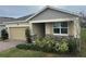 One-story home with a beige exterior, stone accents, and a two-car garage at 29567 Caspian St, Leesburg, FL 34748