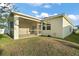 Home exterior showcasing a screened patio and grassy yard at 29567 Caspian St, Leesburg, FL 34748