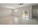 Spacious living area with tile floors, neutral walls, and sliding glass doors to patio at 29567 Caspian St, Leesburg, FL 34748