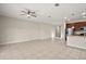 Open living room with tile floor and kitchen view at 29567 Caspian St, Leesburg, FL 34748