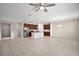 Open concept living room with tile floors and ceiling fan at 29567 Caspian St, Leesburg, FL 34748